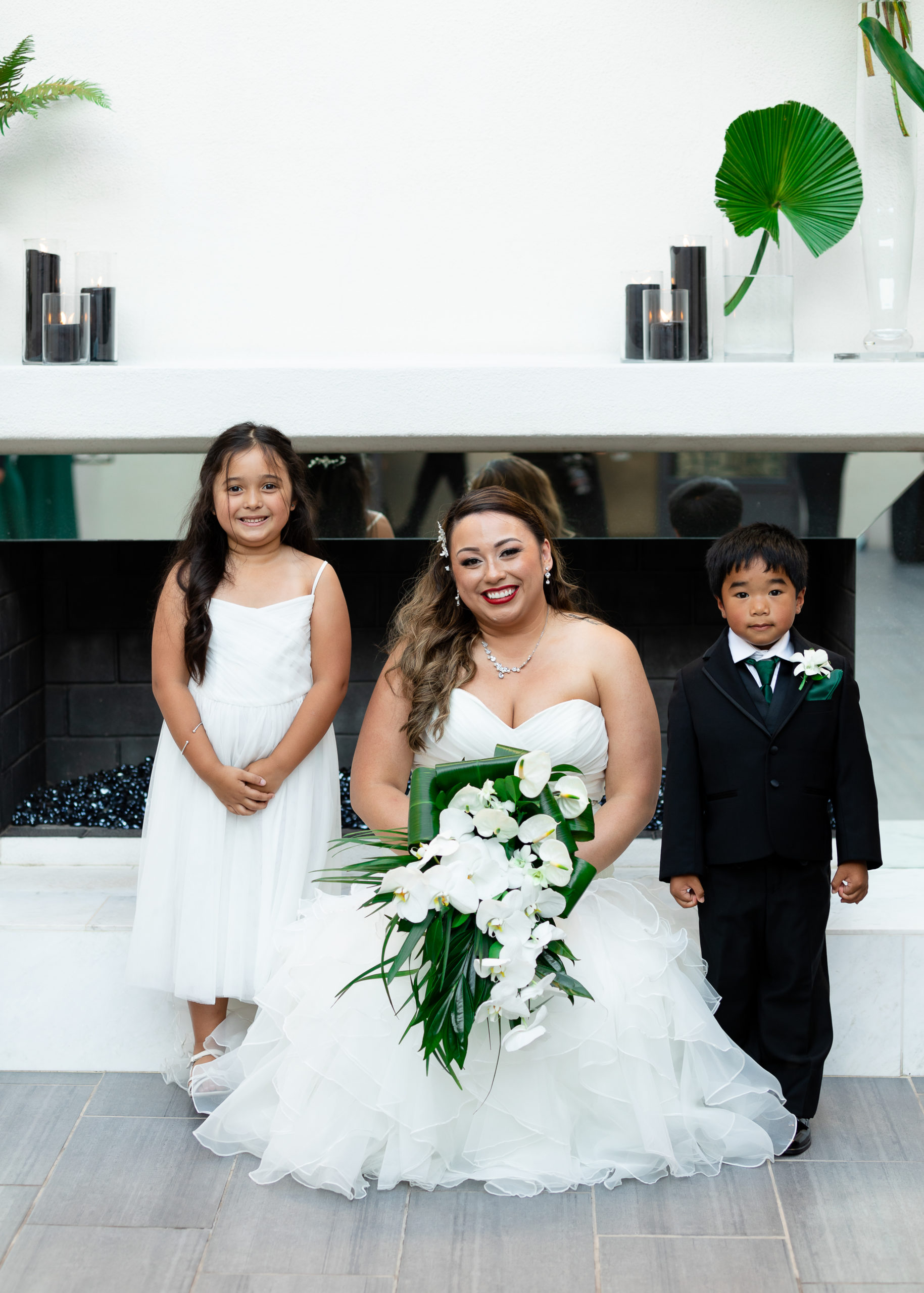 bride smiles with flower girl and ring bearer