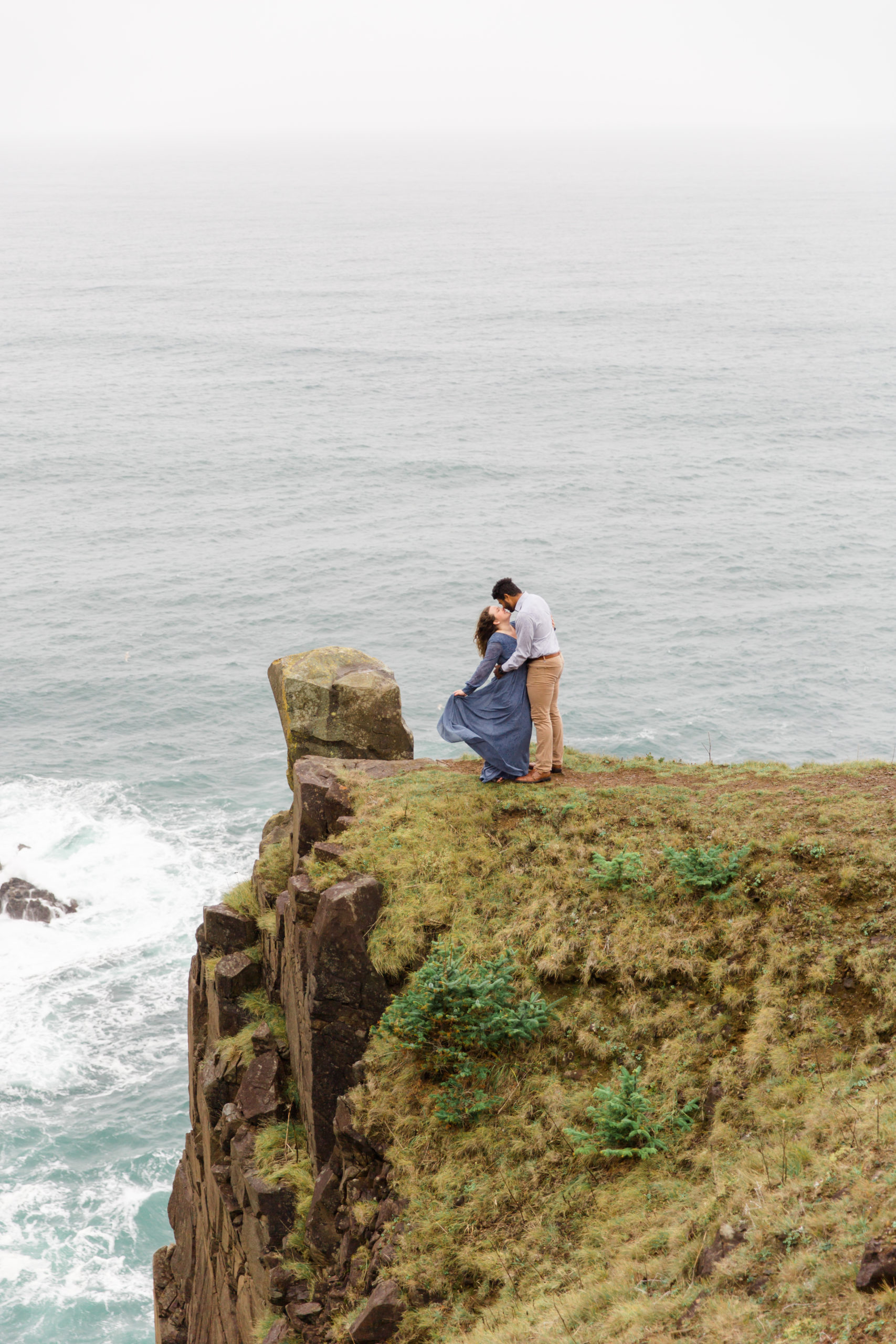 couple pose on cliffs of oregon coast