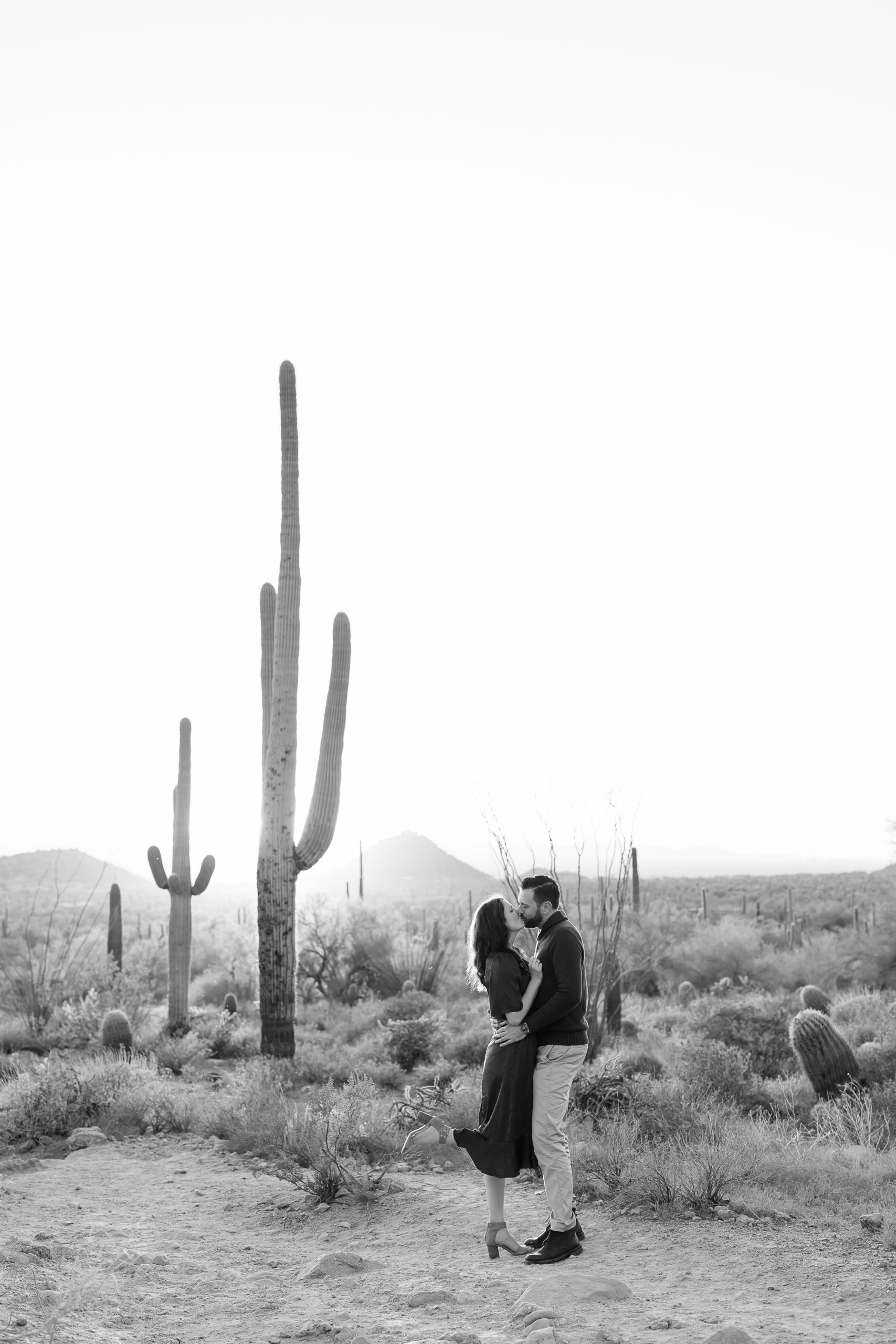 couple kisses in arizona desert