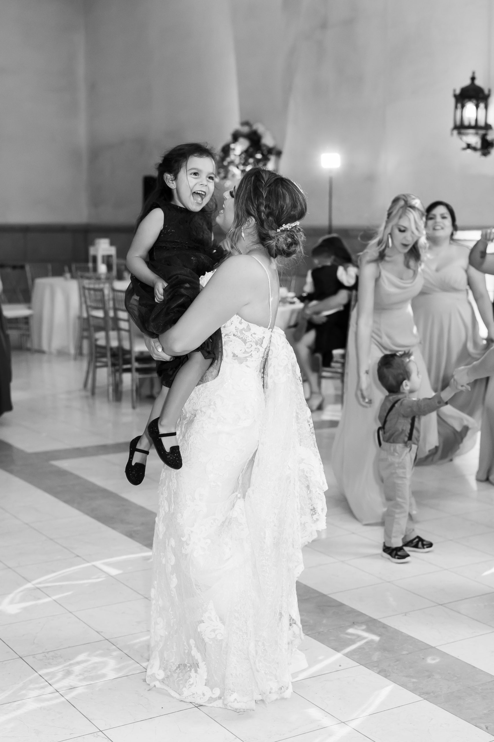 bride dances with younger guest