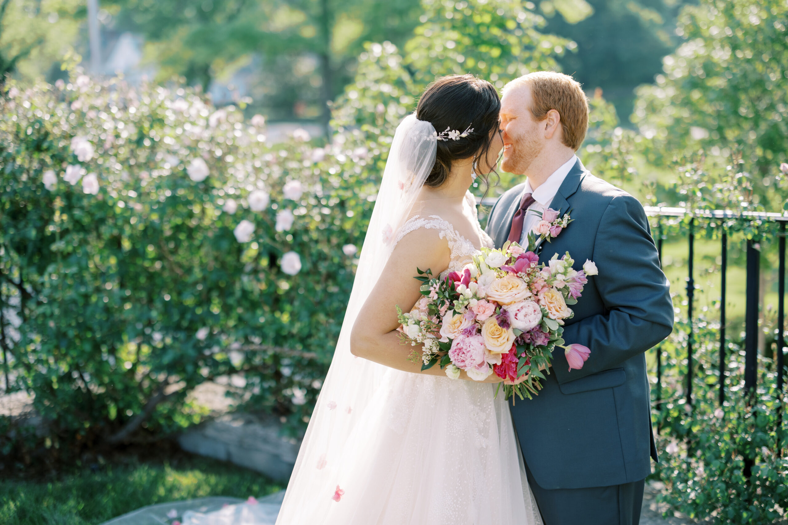 bride and groom kiss during spring wedding